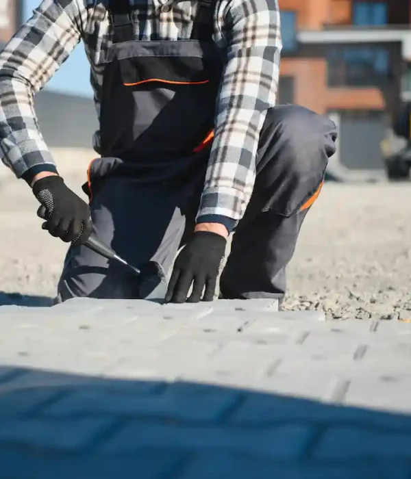 builder-laying-a-paving-brick-placing-it-on-the-sa-2026-01-11-10-12-58-utc